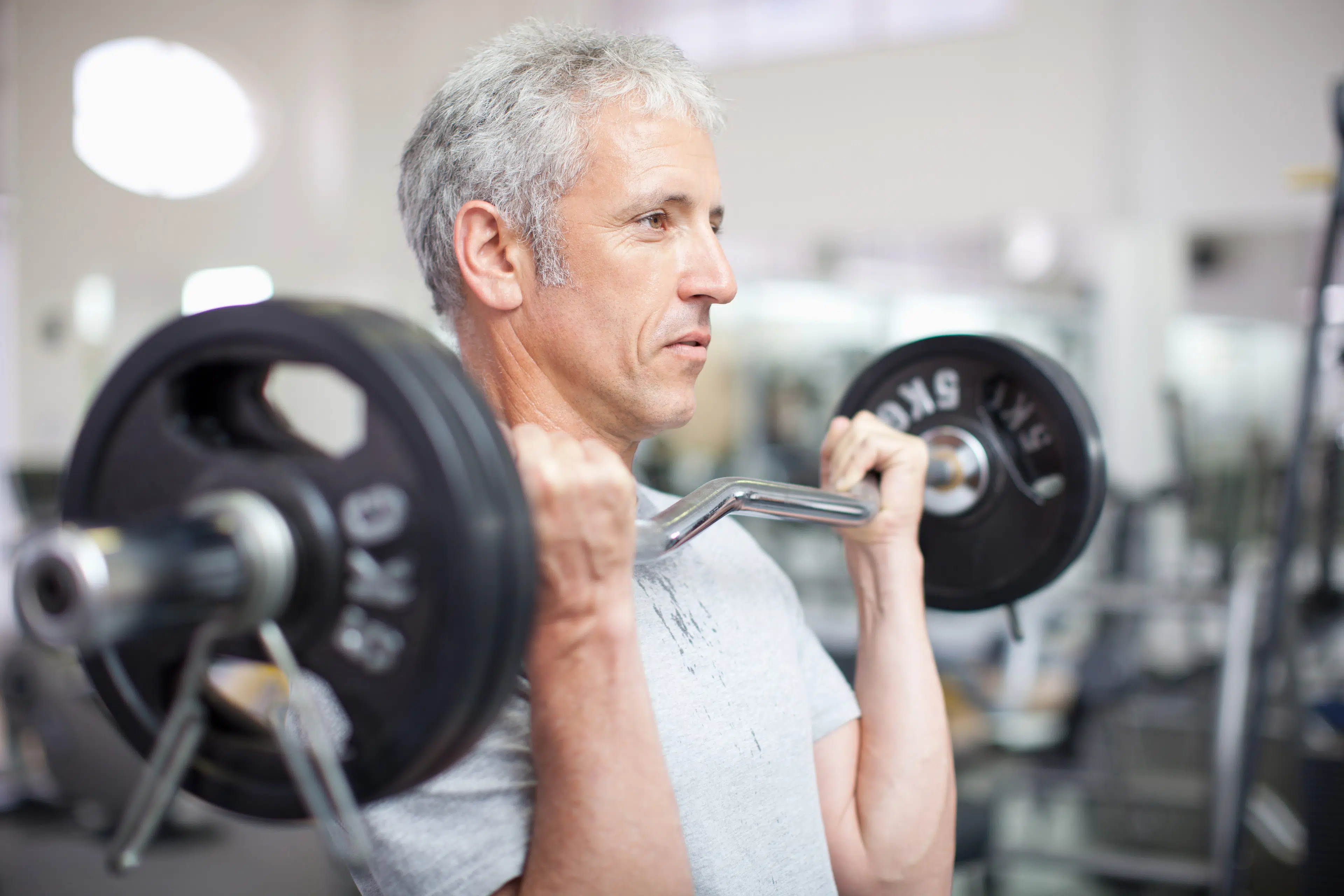 Man lifts a barbell at gym