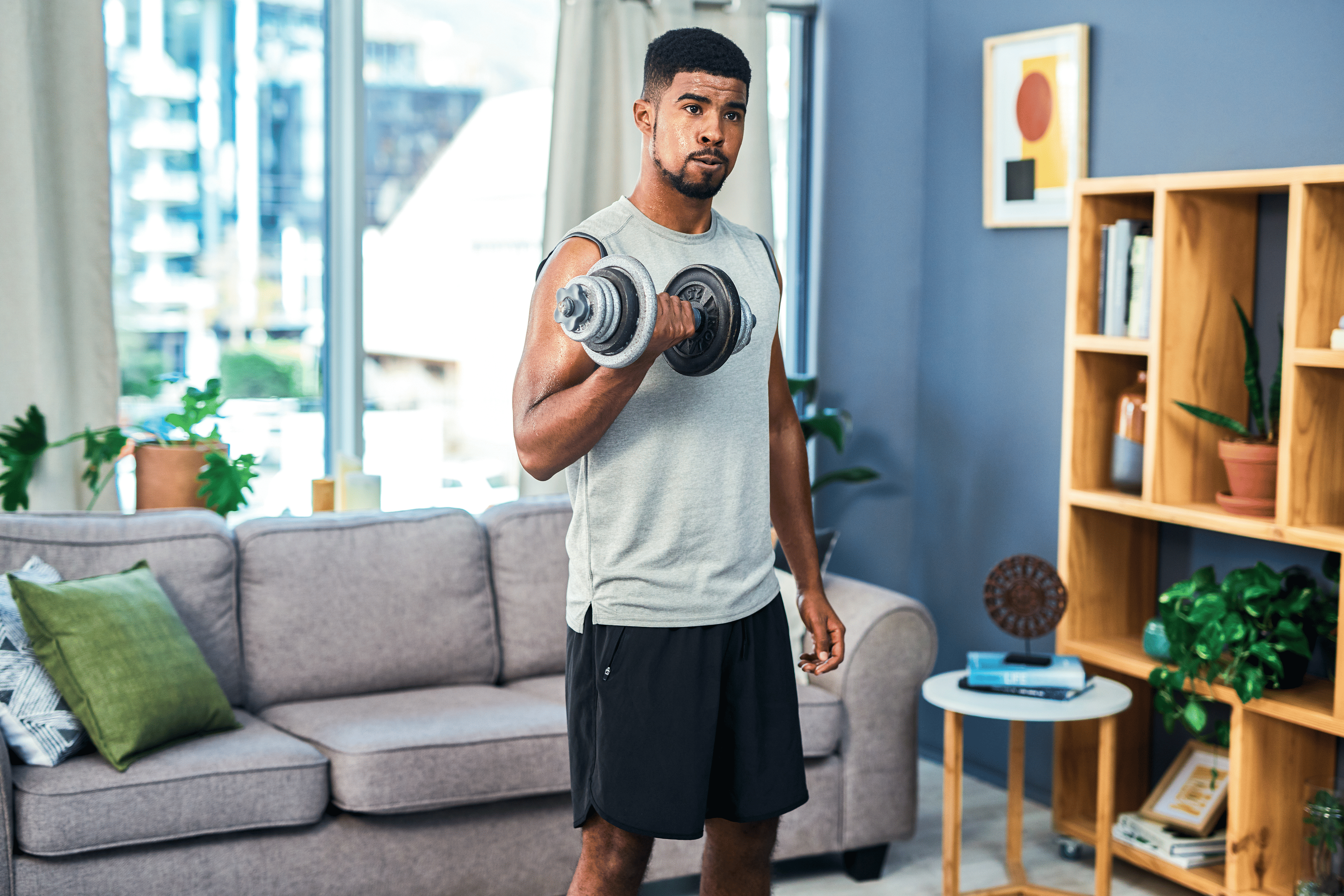 Man lifts weight at home