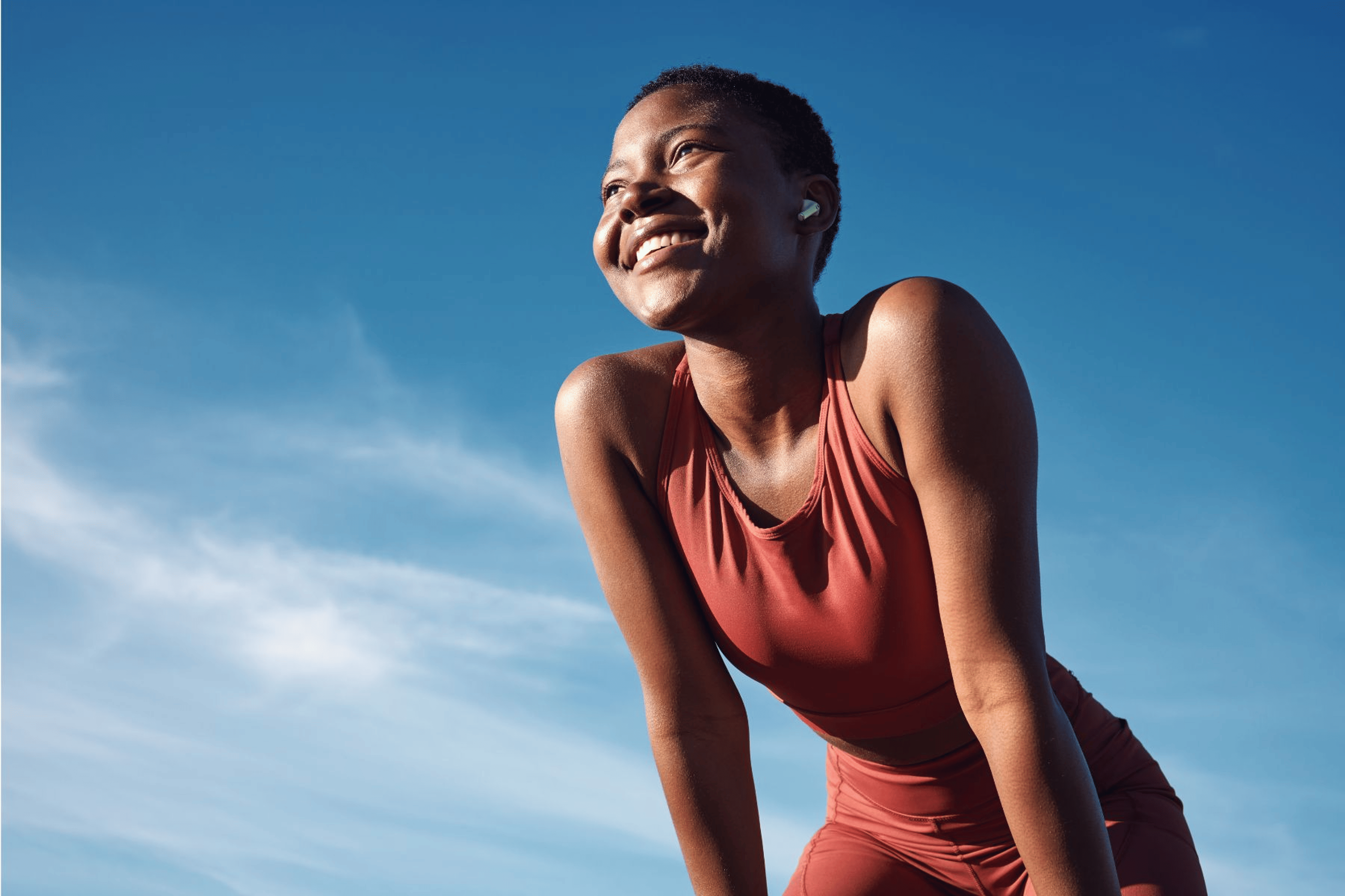 Woman smiling while exercising outside