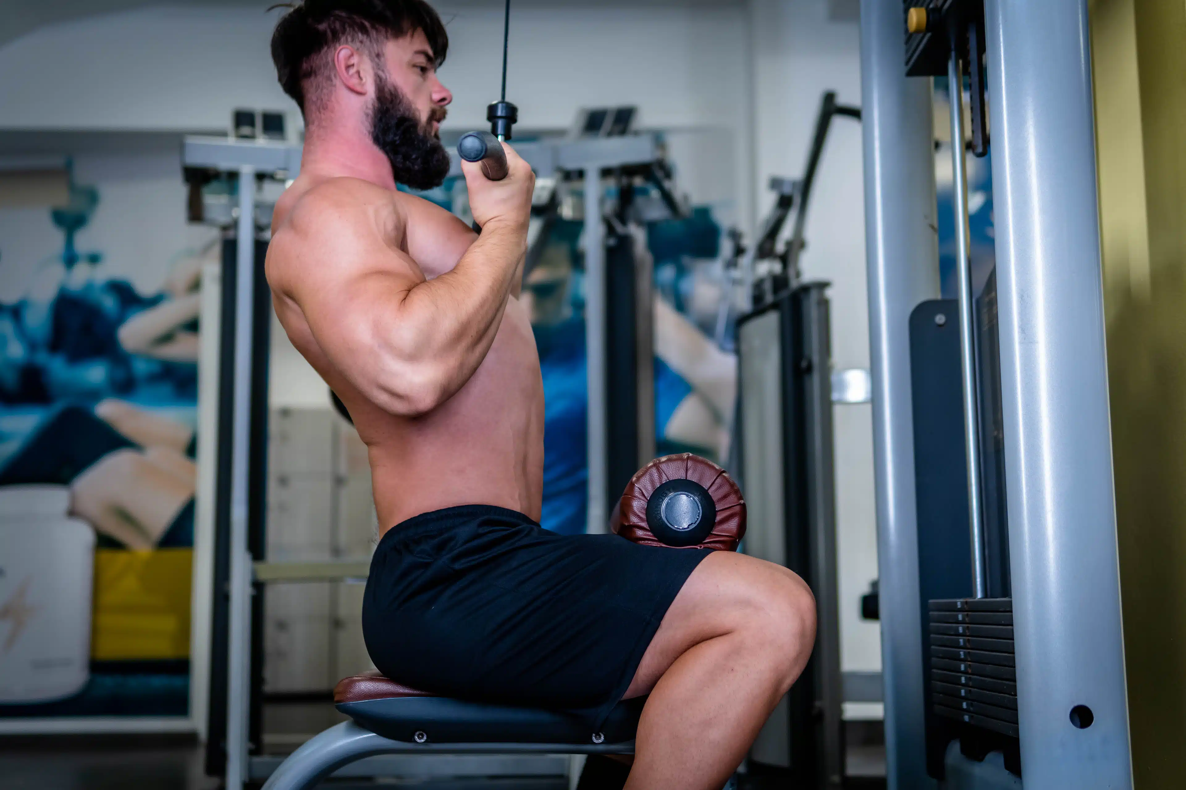 Man performs a reverse grip lat pulldown at gym