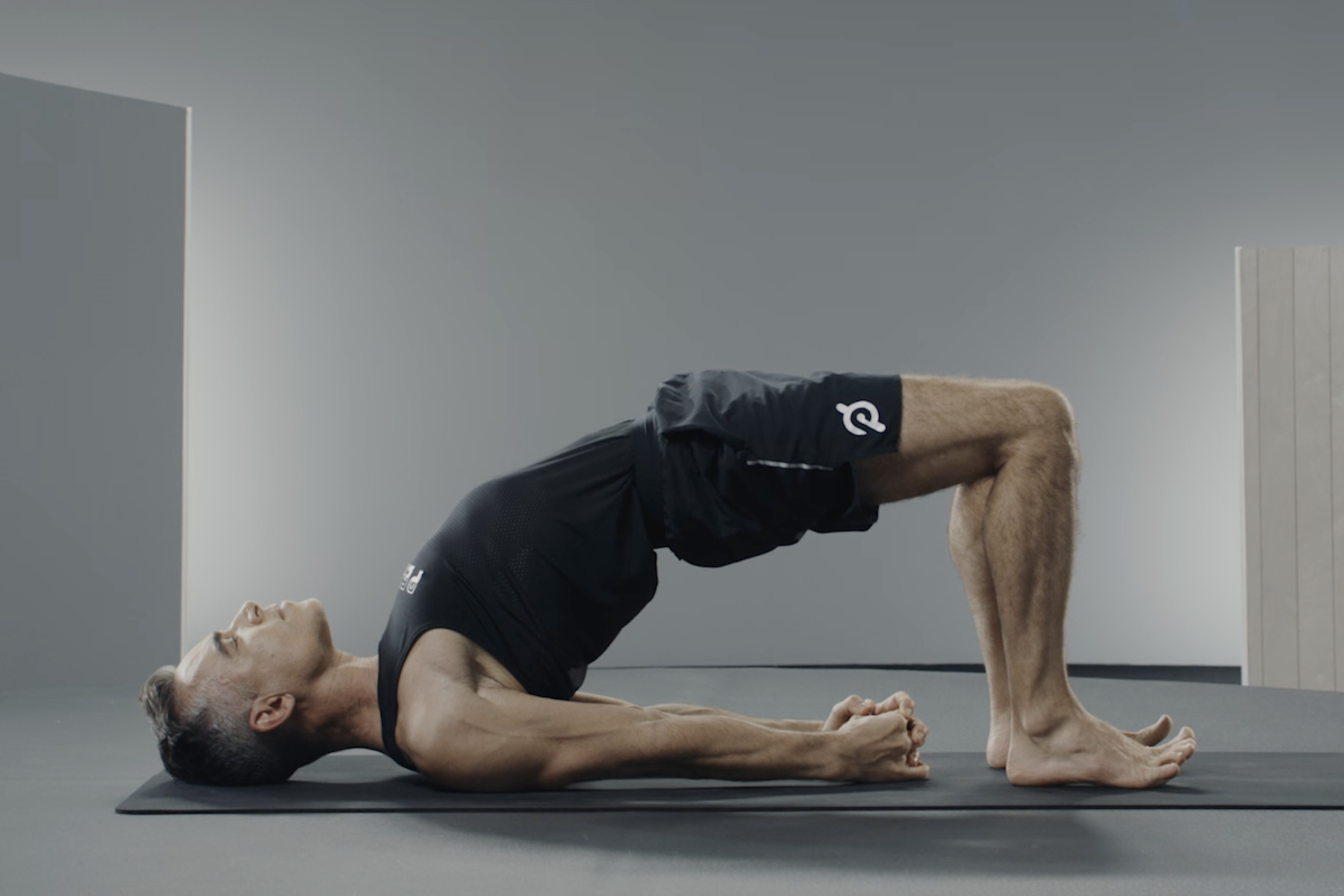 Man demonstrates Bridge Pose, a yoga inversion