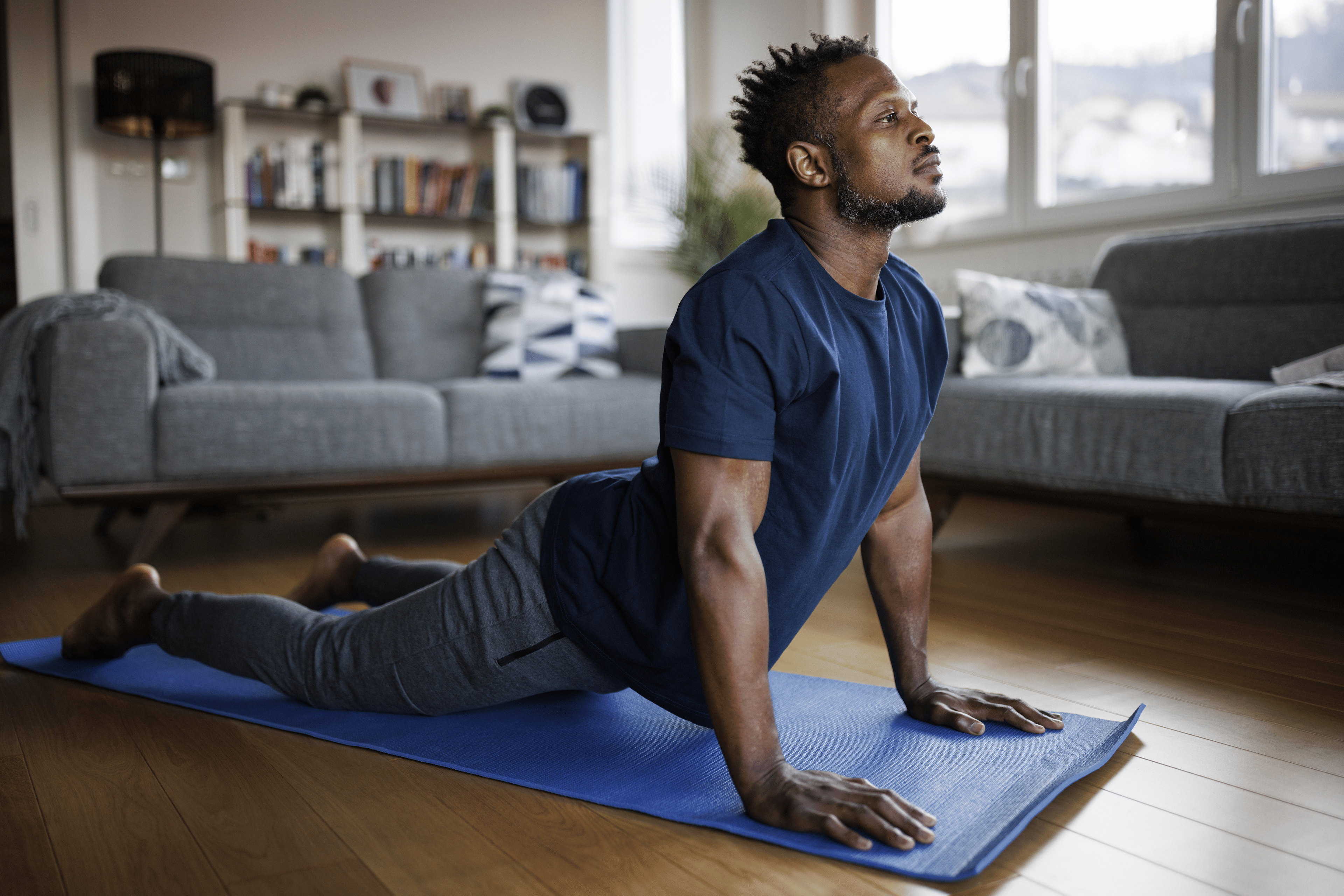 Man doing at-home yoga for his lower back.