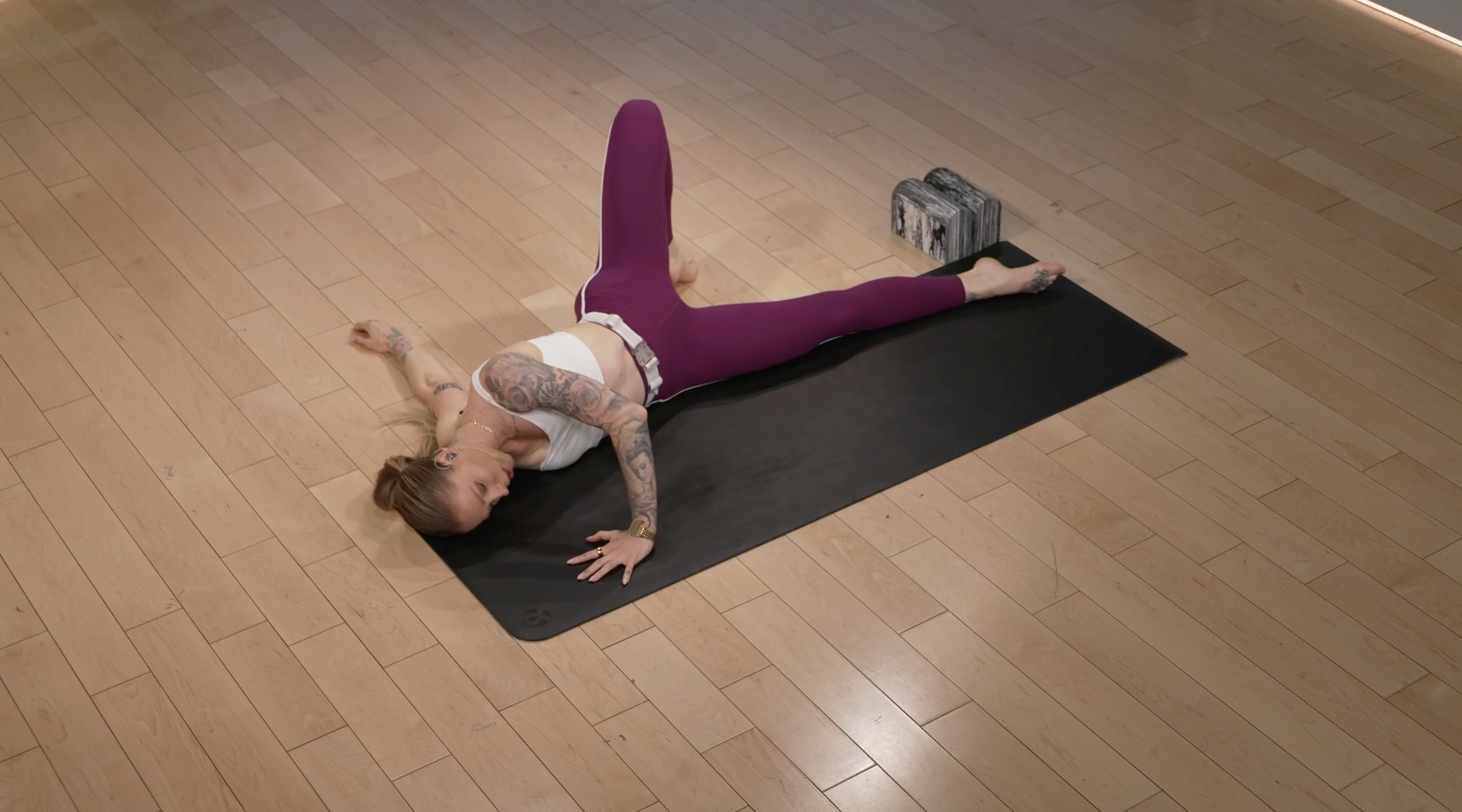 Peloton instructor Kirra Michel demonstrates the scorpion stretch.